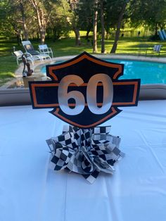 a table with a sign that says 50 on it and a ribbon around the edge