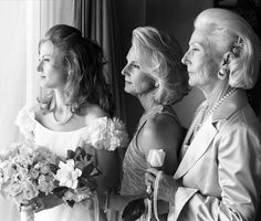 two women and one man are looking at each other in the same photo on their wedding day