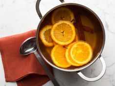 a pot filled with orange slices on top of a table