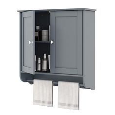 a gray cabinet with two towels hanging from it's sides and one door open