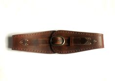 "This beautiful waist belt is made with a gorgeous semi- veg tanned leather. The material chosen is the best quality leather with a 3mm thickness.  It is sturdy, durable and will aged nicely. The belt is designed to fastened at the front. The buckle is 4.5 cm high and 7 cm long and antique brass finished for all colours. The front panel height is about 10cm, the side about 6cm and at the centre back it is about 5.5cm. It does varies tiny bit from size to size to keep the proportion. The sizes work as below. The measurements being taken at the natural waist which refers to the narrowest point between the bottom of the rib cage and the pelvis, about 1\" above the belly button. When you measure yourself make sure you allow breathing allowance. Choose your size: XS              63.5 - 68.5 cm Brown Leather Corset Belt For Festivals, Adjustable Brown Corset Belt With Matching Belt, Brown Leather Corset Belt With Removable Belt, Vintage Brown Corset Belt With Belt Loops, Leather Corset Belt For Festivals, Vintage Brown Corset Belt For Festivals, Brown Corset Belt For Festivals, Brown Leather Corset Belt, Cincher Belt