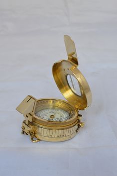 an open brass compass on a white background