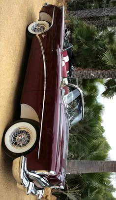 an old car is parked on the side of the road