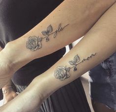 two women with matching tattoos on their arms, one has a name and the other has roses