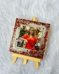 a small wooden easel with a photo on it