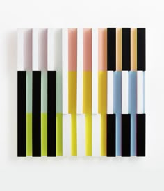 several different colored lines on a white wall with one black and one yellow line in the middle