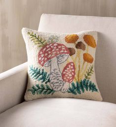 a white chair with a mushroom pillow on it