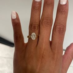 a woman's hand with a diamond ring on it