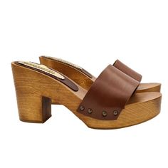 Brown clogs are a great classic of every season. These shoes are perfect for any occasion! Brown wooden base clogs Brown leather band Heel height 9 cm and plateau 3 cm Stable and comfortable made entirely in ITALY. Craftsmanship. BEFORE COMPLETING YOUR PURCHASE DO NOT FORGET TO CHECK THE SIZE! Length along the curve: 37 EU = 6 US = UK 5 = 24.50 CM + WIDTH 8 CM 38 EU = 7 US = UK5.5 = 25.00 CM + WIDTH 8 CM 39 EU = 8 US = UK 6 = 26.00 CM + WIDTH 8 CM 40 EU = 9 US = UK6.5 = 26.50 CM + WIDTH 8.5 CM 4 Brown High Heel Mules With Deep Heel Cup, Classic Brown High Heel Mules, Brown Closed Toe Mules With Deep Heel Cup, Classic Brown Open Heel Mules, Brown High Heel Mules With Wooden Heel, Classic Brown Mules With Stacked Heel, Classic Open Toe Leather Clogs, Classic Brown Open Toe Mules, Classic Leather Open Toe Clogs