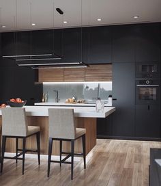 a kitchen with black cabinets and white counter tops next to a dining room table filled with chairs