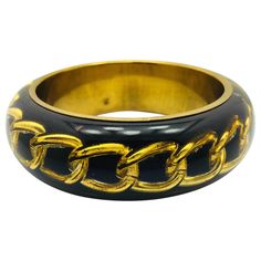 Black Resin bangle bracelet featuring inlaid gold chain. Measurements : total diameter approx. 9.1 cm (3.58 inches) / inner diameter approx. 6.4 cm (2.52 inches) / thickness approx. 0.9 cm (0.35 inch). FOLLOW MEGHNA JEWELS storefront to view the latest collection & exclusive pieces. Meghna Jewels is proudly rated as a Top Seller on 1stDibs with 5 star customer reviews. All items manufactured by us are handmade and can be customized or redesigned. Round Black Metal Chain Bracelet, Gold Bracelets With Black Enamel, Black Metal Bangle For Formal Events, Modern Black Bangle, Formal Black Metal Bangle, Modern Black Round Bangle, Formal Black Enamel Bangle, Retro Bracelet, Resin Bangles