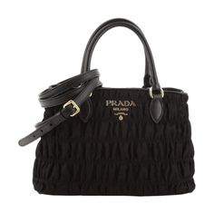 This Prada black tessuto gaufre nylon handbag is luxurious and practical. There are three interior compartments with a zip divider, which is great for organizing and separating your personal belongings. The nylon material is durable and looks sleek with the black saffiano leather trim. The gold Prada Paris logo also goes beautifully with the black nylon. This designer bag is great for everyday use and can also be carried by the handles or adjustable strap.    Model: 1BA173  Black tessuto gaufre Elegant Nylon Tote Bag, Elegant Top Handle Nylon Bags, Luxury Nylon Evening Bag, Elegant Nylon Top Handle Bags, Luxury Evening Nylon Bag, Elegant Evening Nylon Bag, Elegant Nylon Shoulder Bag For Shopping, Designer Nylon Shoulder Bag With Top Carry Handle, Luxury Nylon Bags For Daily Use