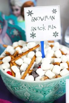 a bowl filled with marshmallows on top of a table next to a sign