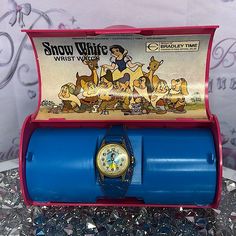 a watch in a blue case sitting on some tinsel