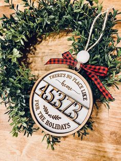 there's no place like home for the holidays ornament on a wooden table