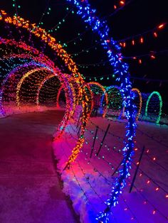 colorful lights decorate the walkway at night