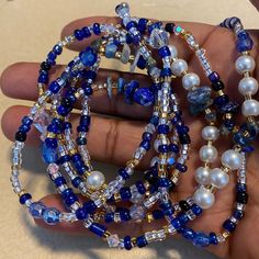 This handmade waist bead is made with a mix of blue clear, gold seed beads size 8/0 and it has lapis lazuli crystals and imitated Swarovski crystals, all spiritually mixed together with white 6 mm pearl glass beads. Waist Bead will fit up to 50 inches  You can choose  premium stretch cord for removable or nylon string or Wire for permanent. If you add a clasp please include your Waist Size in the personalization section at checkout or leave me a message. Your beads will default to 50 inches and Cheap Adjustable Beaded Chain Waist Beads, Waist Bead Tutorial, Blue Spacer Beads Bracelets For Festivals, Blue Festival Bracelets With Spacer Beads, Spiritual Beaded Waist Beads For Beach, Blue Beaded Chain Bracelets For Beach, Blue Round Beads Waist Beads For Gift, Spiritual Round Waist Beads For Beach, Blue Waist Beads Gift