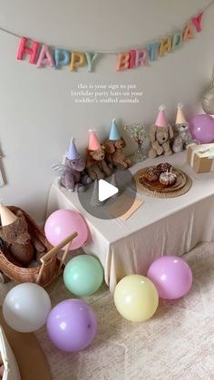 a birthday party with balloons and stuffed animals