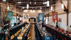 a long table with many place settings and harry potter flags on the wall above it