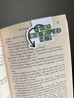 an open book with a green sticker on the page that says i was interrupted here