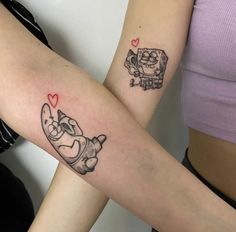 two people with matching tattoos on their arms, one has a cat and the other has a dog