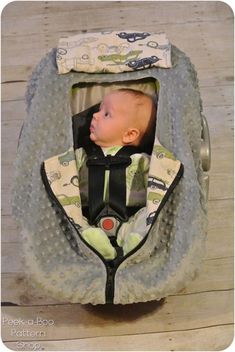 a baby in a car seat that is on the floor