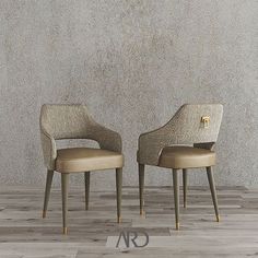 two chairs sitting next to each other in front of a wall