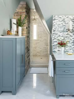 a bathroom with blue cabinets and white tiled walls