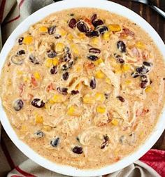 a white bowl filled with oatmeal and raisins on top of a table