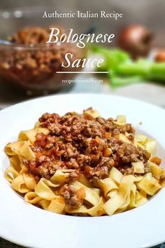 a white plate topped with pasta and meat