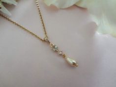 COUPON: FREESHIP50 Spend $50+ Receive FREE FIRST-CLASS DOMESTIC SHIPPING Same Necklace With Sapphire Crystal and Pearl: https://www.etsy.com/listing/1550464505 Wonderful for the Brides "Something Blue," Maid/Matron of Honor/Bridesmaid Gifts, Mother of the Bride/Mother of the Groom Gifts, Formal Event, Special Occasion, Gift for Her... Matching Earrings: https://www.etsy.com/listing/1656312862 https://www.etsy.com/listing/1306841744 https://www.etsy.com/listing/1662032582 Matching Hair Pins: https://www.etsy.com/listing/1571832906 Matching Bracelets: https://www.etsy.com/listing/1612755977 https://www.etsy.com/listing/1744491817 This original design, handmade pendant necklace features a Light Lake Blue Inverted Teardrop and Clear Round CZ Connector with a Pearl Teardrop Dangle in your color Something Blue Necklace, Blue Pearl Drop Necklaces For Wedding, Blue Pearl Drop Necklace For Wedding, Blue Pearl Chain Jewelry For Wedding, Dainty Blue Necklace For Wedding, Blue Pearl Chain Necklace For Wedding, Blue Pearl Chain Necklaces For Wedding, Delicate Blue Necklace For Wedding, Gold Dangle Drop Necklace For Wedding