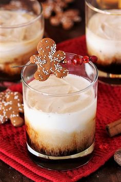 two glasses filled with ice cream and topped with gingerbread cookies on a red napkin