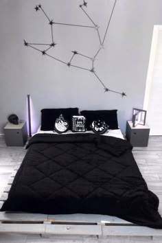 a bed with black comforter and pillows on it