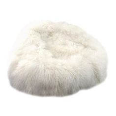 a white sheepskin beanie is shown on a white background, with the fur covering it