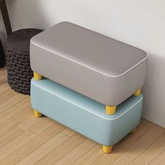 two stools are stacked on top of each other in front of a white wall