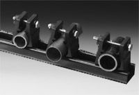 an image of four metal pipes on a black and white background with space for text