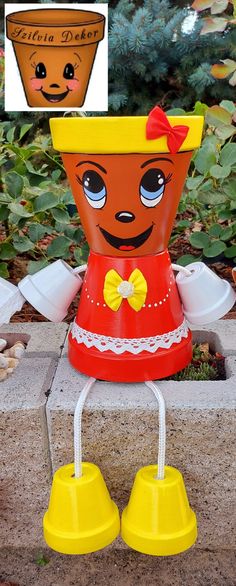 an orange and yellow flower pot sitting on top of a cement block next to a planter