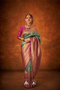 a woman in a pink and green sari