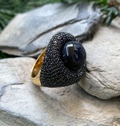 "14k Yellow Gold Sterling Silver Black Onyx Orb Pave Black Spinel Nest Ring Size 6.5 up for offer is a stunning 14k yellow gold over solid sterling silver black onyx orb set in a nest of pave black spinel ring. This ring is marked \"925\". Measurements Ring Size: 6.5 Band Width: 4mm Black Onyx Orb: 13mm Black Spinel: 1.3mm Weight: 9.5 g Materials -14k Yellow Gold -Sterling Silver -Black Onyx -Black Spinel Condition: New; Please look closely at the pictures provided as they are an extension of th Formal Black Dome Ring With Polished Finish, Black Oval Ring With Black Diamonds, Black Oval Rings With Black Diamonds, Oval Black Rings With Black Diamonds, Gift Black Sapphire Ring With Black Diamonds, Black Sapphire Ring With Black Diamonds As Gift, Formal Black Sapphire Ring With Accent Stones, Luxury Black Spinel Round Ring, Black Sapphire Ring With Gemstone In Luxury Style