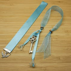 a blue ribbon with two keys attached to it