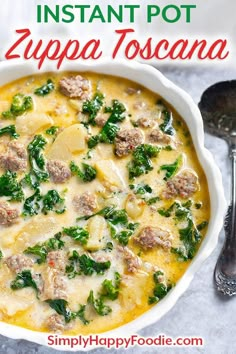 a white bowl filled with soup and meatballs on top of a table next to a spoon