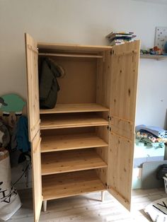 an open wooden cabinet in a room