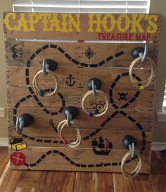 a wooden board game with ropes and magnets attached to it's sides on the floor