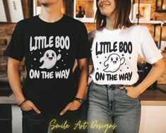 Get ready to reveal your pregnancy with our hilarious Halloween pregnancy announcement shirts! These funny tees blend spooky season with baby-on-the-way excitement, a perfect way for couples to share their boo-tiful news with a side of humor. Spread the laughter and announce your little Boo on the way in style with these spooky and maternity-approved Halloween tees! These T-shirts are UNISEX SIZING true to size, if you looking for oversized look size up. Check sizing in pictures for the best fit Funny Black Tops For Gender Reveal, Fun T-shirt With Custom Print For Gender Reveal, Fun Custom Print T-shirt For Gender Reveal, Cute Black T-shirt With Funny Text, Funny White T-shirt For Gender Reveal, Black Graphic Tee For Gender Reveal, Black T-shirt With Funny Text For Gender Reveal, Funny T-shirt For Gender Reveal, Funny Crew Neck T-shirt For Gender Reveal