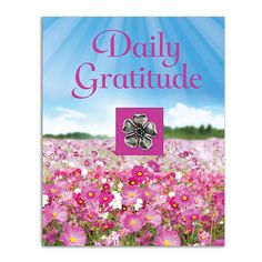 the front cover of a book with pink flowers and blue sky in the background, which reads daily gratitude