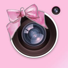 a camera with a pink bow on it's front and the lens facing upwards