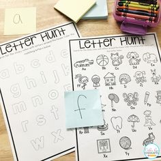 two letter hunt worksheets with colored pencils and crayons on the table