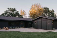 a large house with two garages in the front and one on the other side