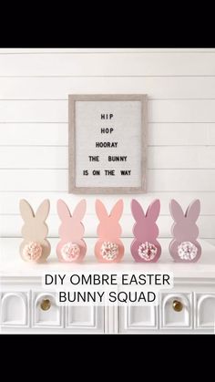 some bunny ears sitting on top of a white dresser next to a sign that says diy ombre easter bunny squad