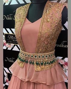 a pink dress with gold sequins and green beading on the waistline